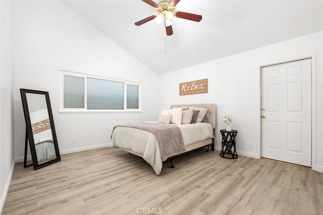 bedroom featuring ceiling fan, lofted ceiling, and light hardwood / wood-style flooring