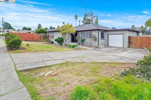 single story home featuring a garage and a front yard