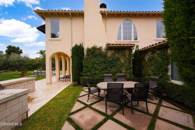 rear view of property featuring a patio