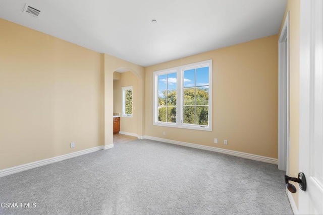 unfurnished room with light colored carpet