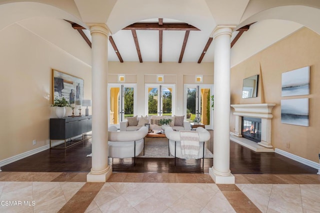 tiled living room with beam ceiling and decorative columns