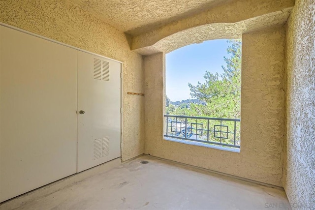 interior space with concrete flooring and a closet