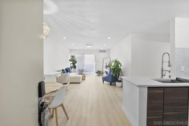 interior space with sink and light hardwood / wood-style floors