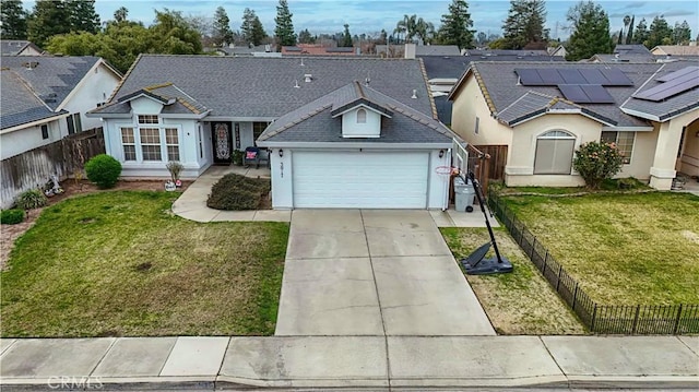 ranch-style house with a garage, a front yard, and solar panels