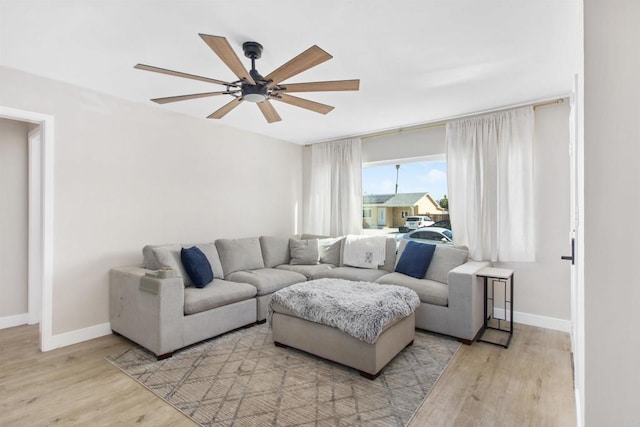 living room featuring light hardwood / wood-style flooring and ceiling fan