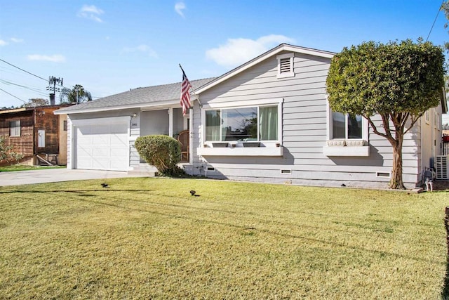 view of front of house featuring a garage and a front lawn