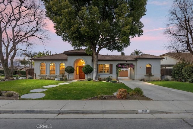 mediterranean / spanish-style house with a yard