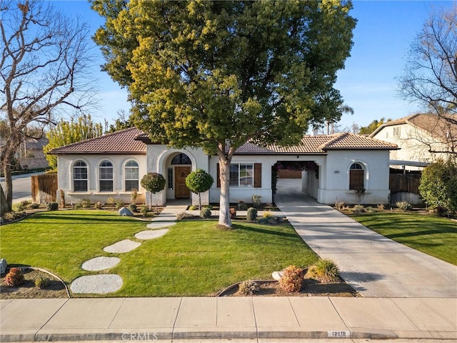 mediterranean / spanish-style house with a front yard