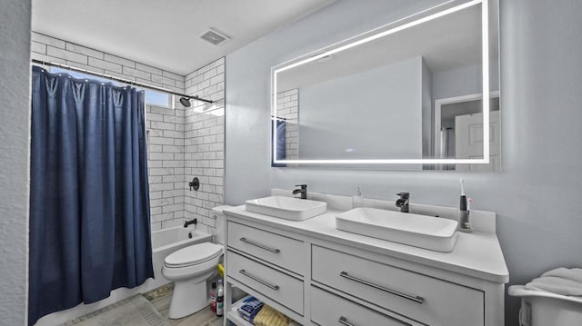 full bathroom with vanity, shower / bath combination with curtain, and toilet