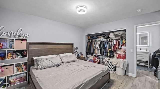 bedroom with hardwood / wood-style flooring and a closet