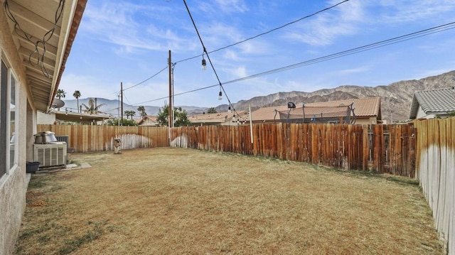 view of yard featuring a mountain view and central air condition unit