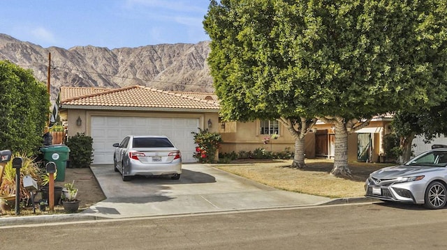 view of front of house featuring a garage and a mountain view