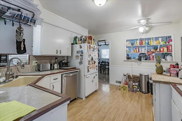 kitchen with sink, stainless steel appliances, and white cabinets