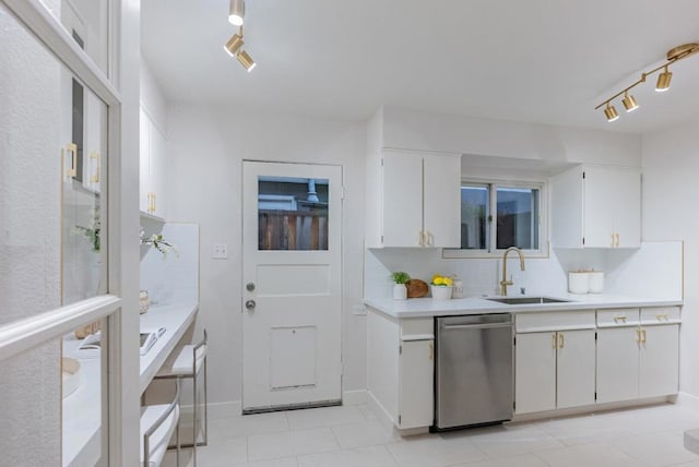 kitchen with white cabinetry, track lighting, dishwasher, and sink