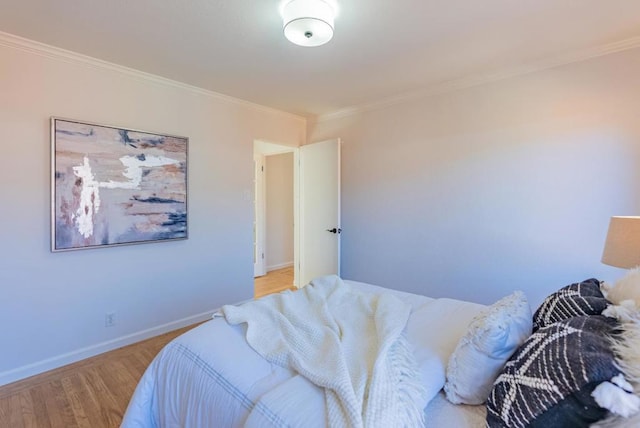 bedroom featuring crown molding and light wood-type flooring