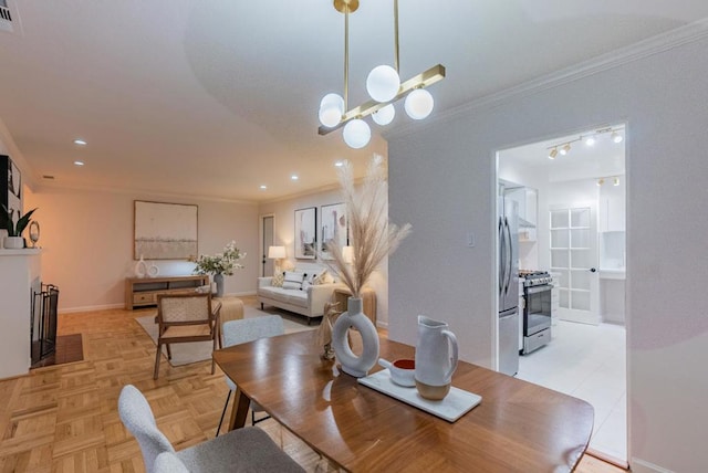 dining room with ornamental molding, a chandelier, and light parquet floors