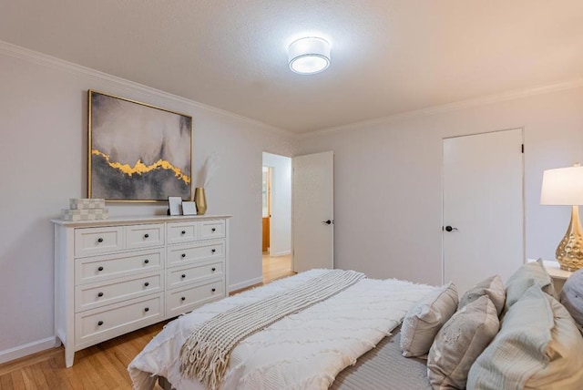 bedroom featuring ornamental molding and light wood-type flooring