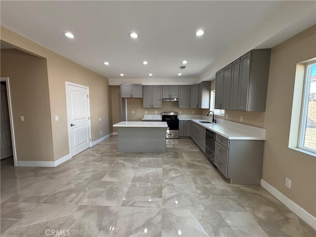 kitchen featuring gray cabinets, a kitchen island, dishwasher, sink, and stainless steel range