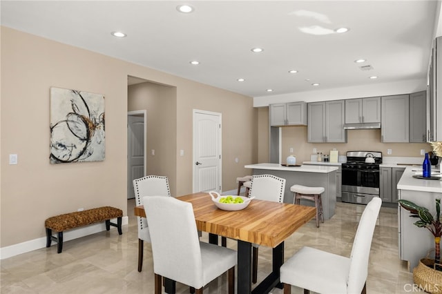 dining room featuring baseboards and recessed lighting