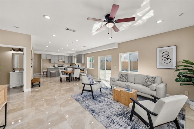 living room featuring ceiling fan, marble finish floor, visible vents, and recessed lighting