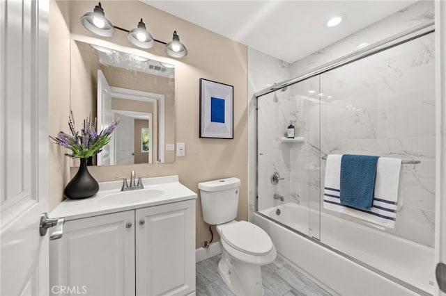 bathroom with visible vents, shower / bath combination with glass door, vanity, and toilet