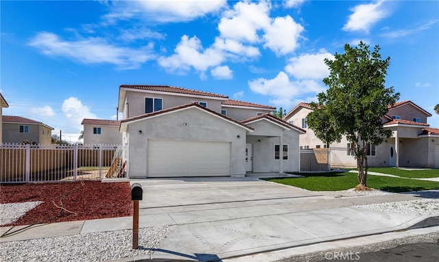 mediterranean / spanish home with fence, driveway, an attached garage, and stucco siding