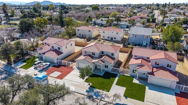 drone / aerial view featuring a residential view and a mountain view