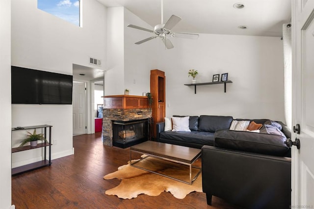 living room with dark wood-type flooring, a fireplace, and ceiling fan