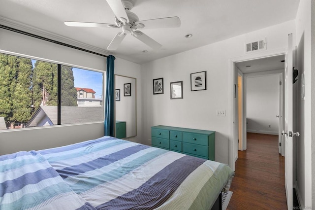 bedroom with dark hardwood / wood-style floors and ceiling fan