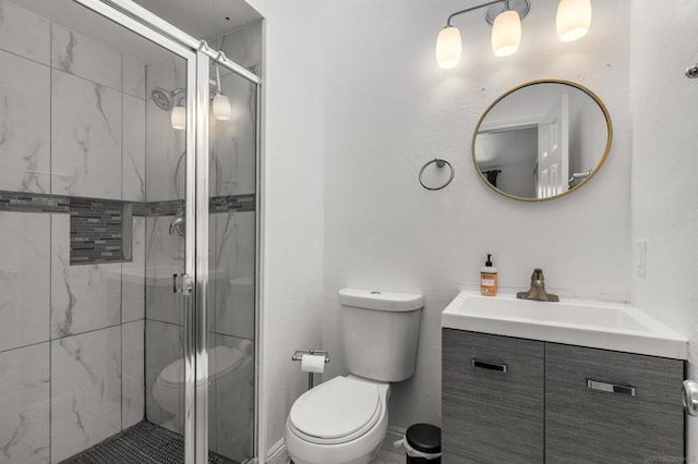 bathroom with vanity, an enclosed shower, and toilet