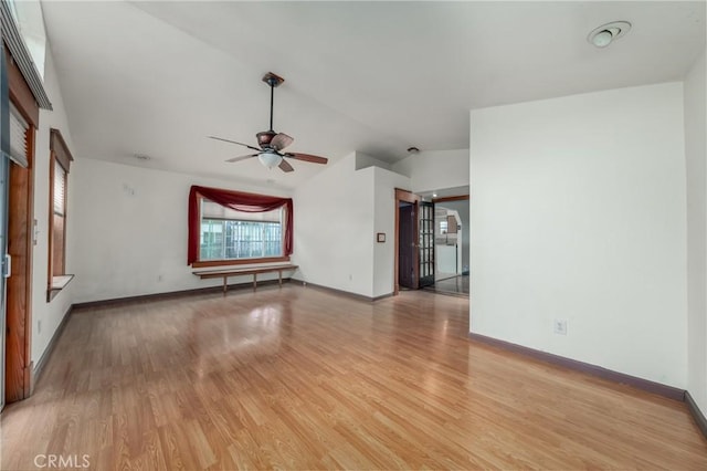 unfurnished living room with vaulted ceiling, ceiling fan, and light hardwood / wood-style flooring