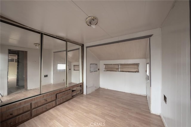 bathroom with lofted ceiling and hardwood / wood-style floors