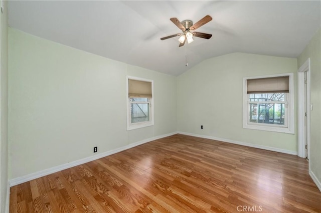 empty room featuring lofted ceiling, ceiling fan, and light hardwood / wood-style flooring