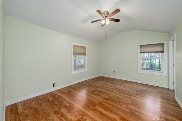 unfurnished bedroom featuring ceiling fan, light wood-type flooring, and vaulted ceiling