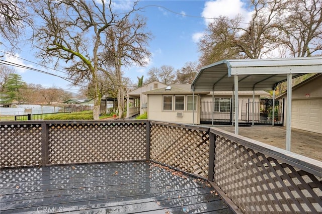 wooden deck featuring a garage and a carport