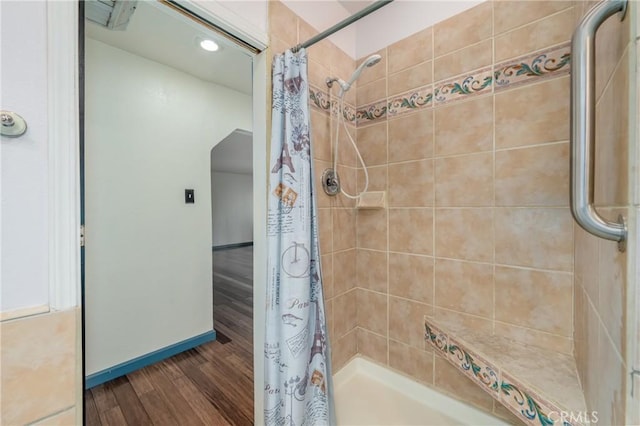 bathroom featuring hardwood / wood-style flooring and curtained shower