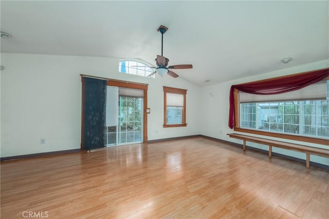 unfurnished living room featuring light hardwood / wood-style flooring, ceiling fan, and vaulted ceiling