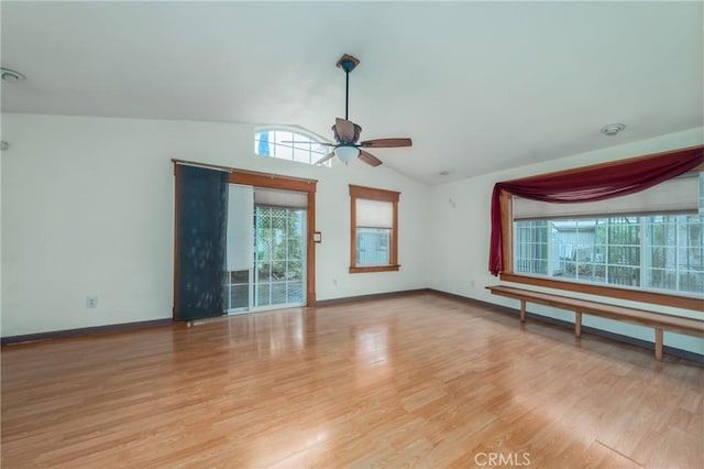 empty room featuring lofted ceiling, ceiling fan, and light hardwood / wood-style flooring