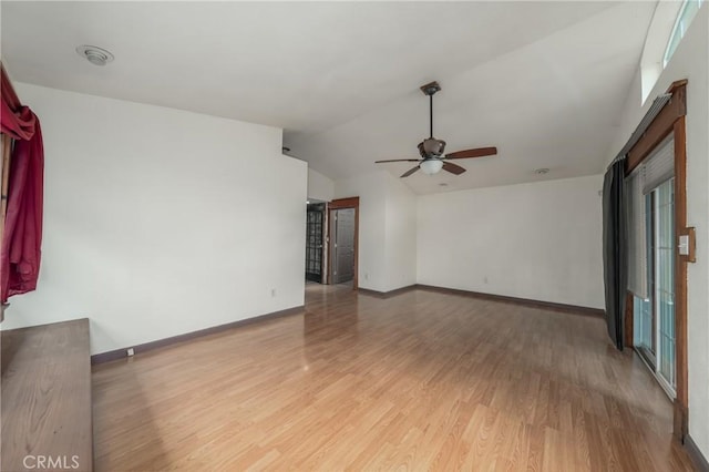 empty room with wood-type flooring, ceiling fan, and vaulted ceiling