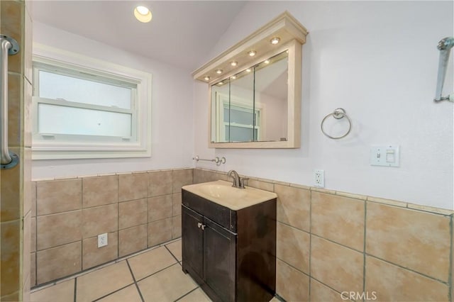 bathroom with tile walls, vanity, and tile patterned floors