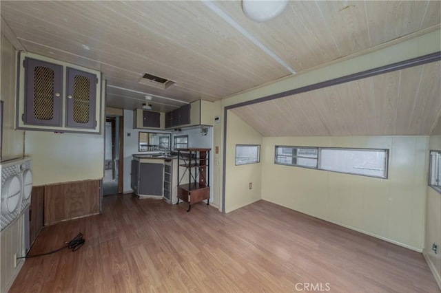 unfurnished living room featuring vaulted ceiling, hardwood / wood-style floors, and wooden ceiling