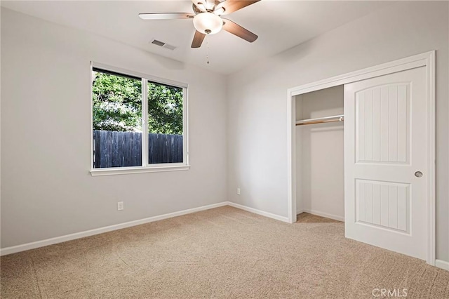 unfurnished bedroom with ceiling fan, carpet floors, and a closet