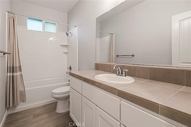 full bathroom with vanity, toilet, shower / tub combo, and wood-type flooring