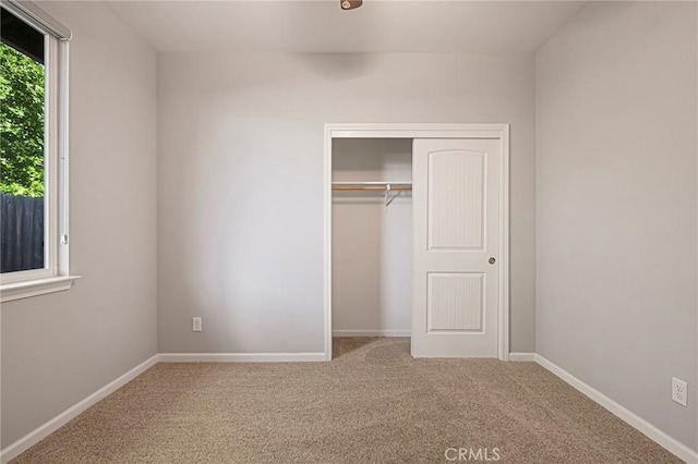 unfurnished bedroom featuring a closet and carpet