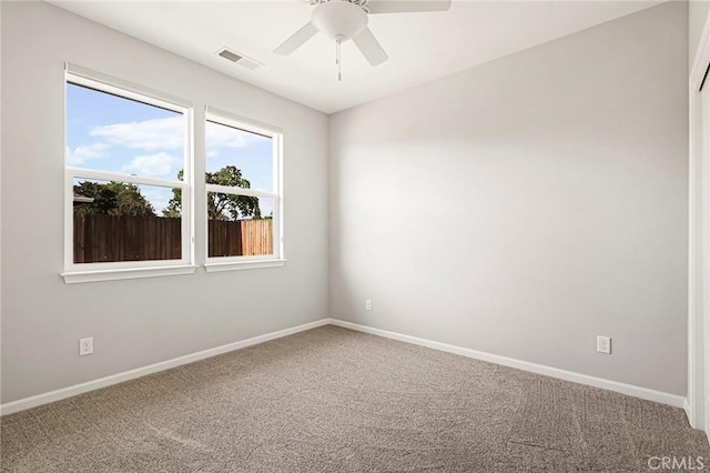 carpeted empty room featuring ceiling fan