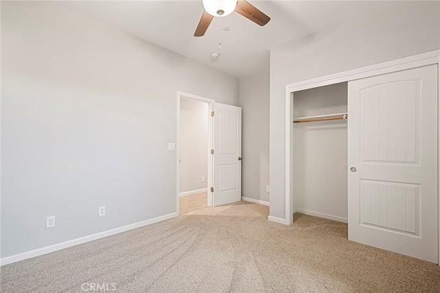 unfurnished bedroom with light carpet, ceiling fan, and a closet