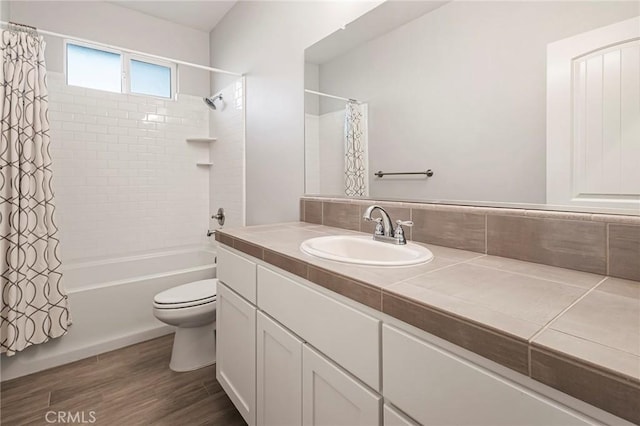 full bathroom featuring toilet, shower / tub combo, vanity, hardwood / wood-style floors, and decorative backsplash