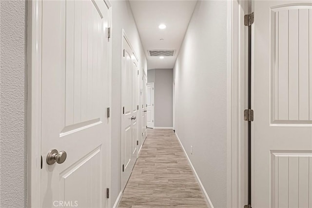 hallway with light wood-type flooring