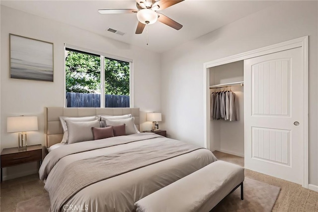 carpeted bedroom with ceiling fan and a closet