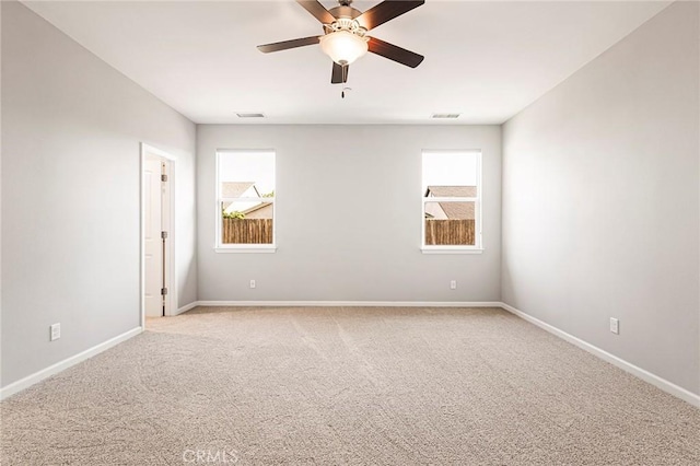 empty room featuring light carpet and ceiling fan